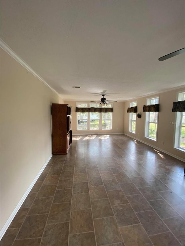 unfurnished room with ceiling fan and ornamental molding