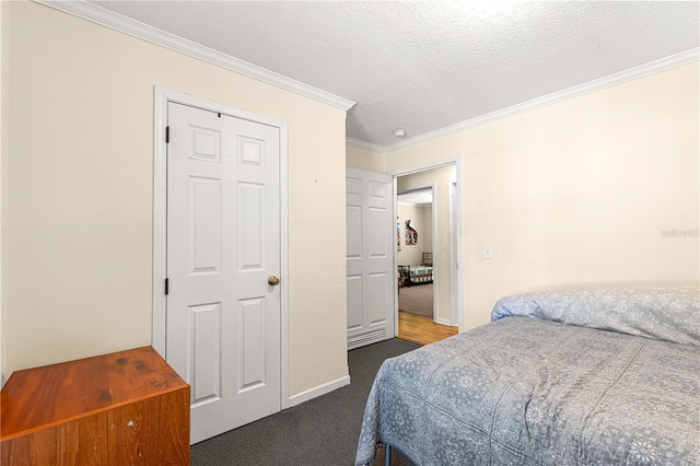 carpeted bedroom featuring a textured ceiling and ornamental molding