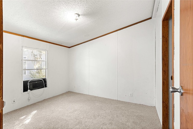 carpeted spare room with cooling unit, ornamental molding, and a textured ceiling