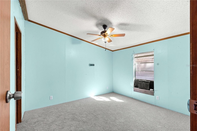 carpeted spare room featuring a textured ceiling, ceiling fan, and ornamental molding