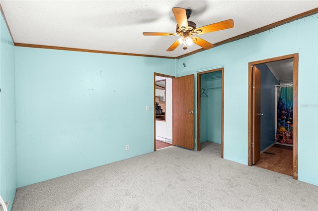 unfurnished bedroom with carpet flooring, ceiling fan, and a textured ceiling