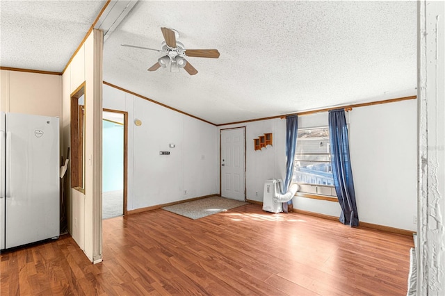 foyer entrance with hardwood / wood-style floors, a textured ceiling, ceiling fan, and ornamental molding