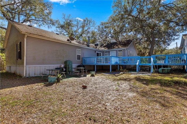 rear view of property with a wooden deck