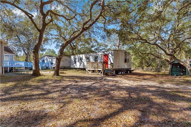 view of yard with a storage unit and a deck