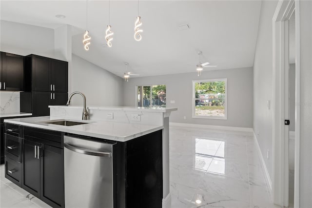 kitchen with a center island with sink, sink, hanging light fixtures, stainless steel dishwasher, and ceiling fan