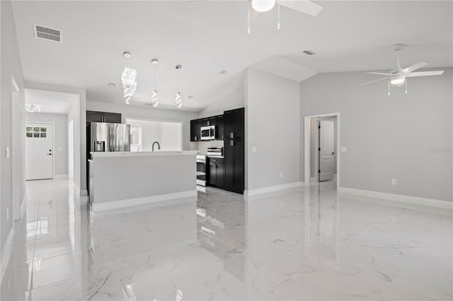 kitchen with high vaulted ceiling, a center island with sink, ceiling fan, decorative light fixtures, and stainless steel appliances