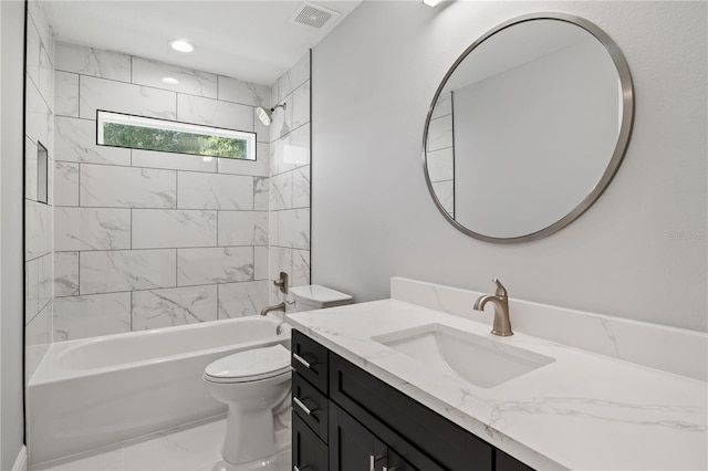 full bathroom featuring tiled shower / bath combo, toilet, and vanity