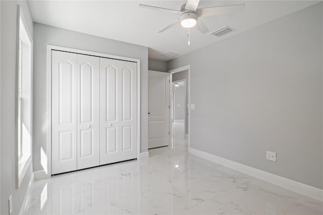 unfurnished bedroom featuring ceiling fan and a closet