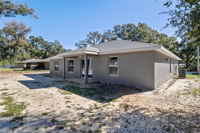 rear view of house featuring central AC unit