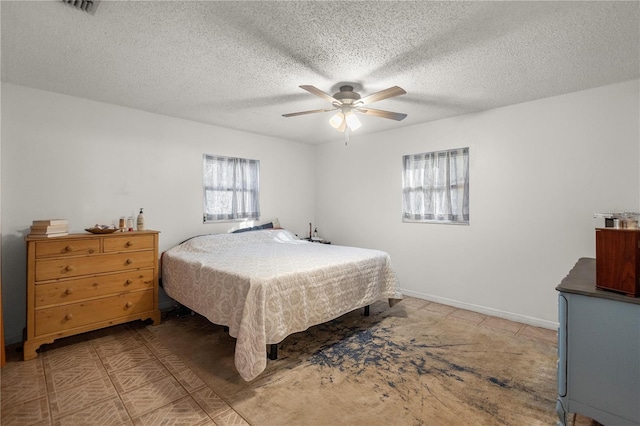 bedroom featuring a textured ceiling and ceiling fan