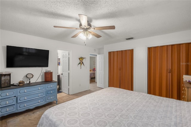 bedroom with ceiling fan and a textured ceiling