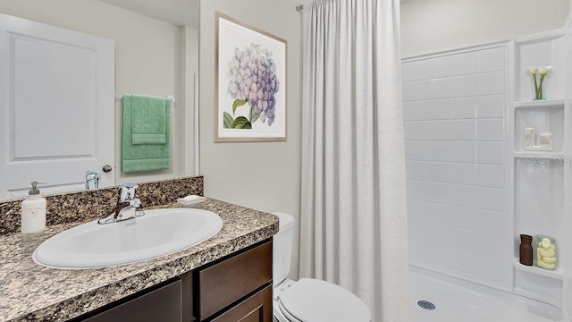 bathroom with vanity, toilet, and curtained shower