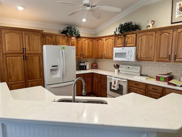 kitchen with backsplash, ornamental molding, white appliances, vaulted ceiling, and sink