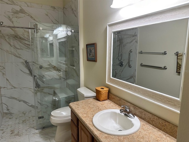 bathroom with a shower with door, vanity, and toilet