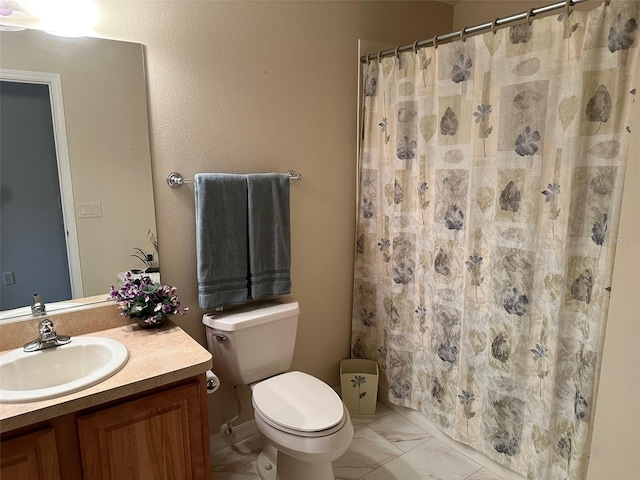 bathroom featuring vanity, toilet, and curtained shower