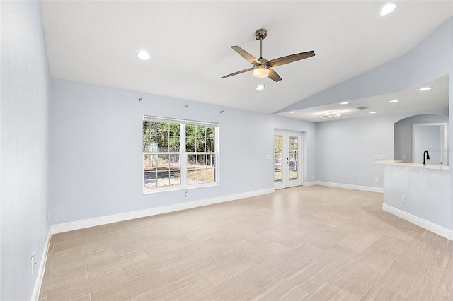 unfurnished room featuring french doors, vaulted ceiling, ceiling fan, and sink