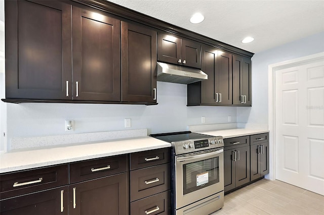 kitchen featuring light stone countertops, dark brown cabinets, and stainless steel electric range