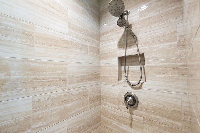 interior details featuring a tile shower