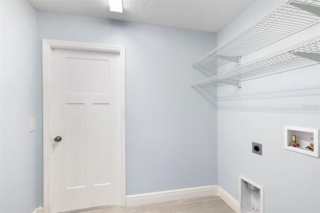 laundry room featuring washer hookup, electric dryer hookup, and light hardwood / wood-style flooring