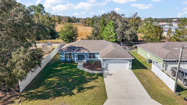 view of front of property featuring a garage and a front lawn