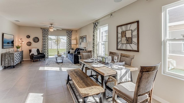 tiled dining space featuring ceiling fan