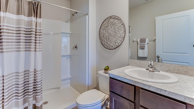 bathroom featuring vanity, curtained shower, and toilet