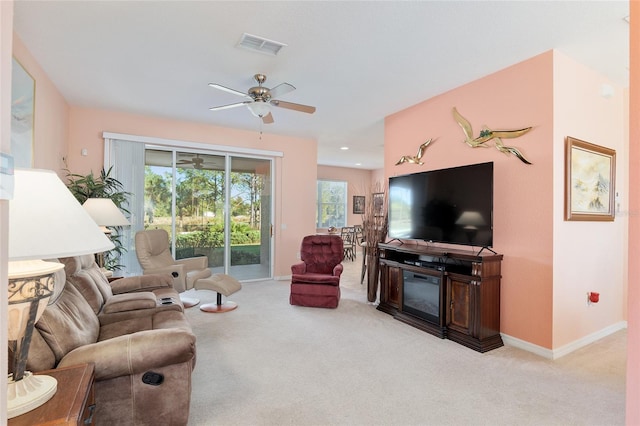 living room featuring light colored carpet and ceiling fan