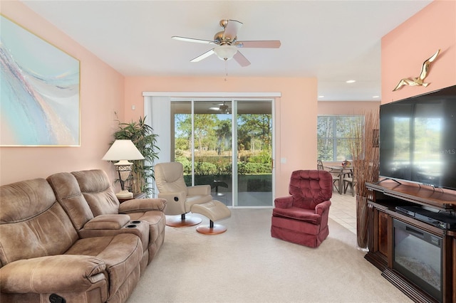 carpeted living room with ceiling fan