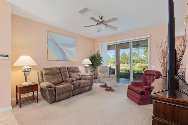 carpeted living room with ceiling fan