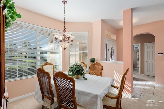 carpeted dining space with a notable chandelier