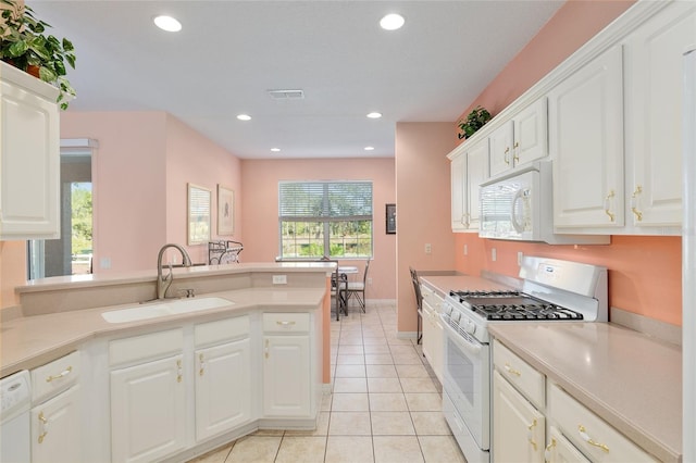 kitchen with white cabinetry, sink, light tile patterned flooring, and white appliances