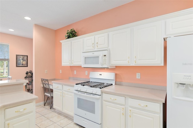 kitchen featuring light tile patterned floors, white cabinets, and white appliances