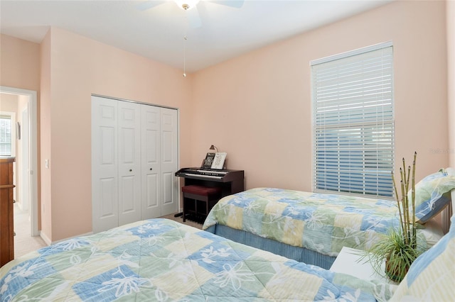 bedroom featuring ceiling fan, a closet, and carpet floors