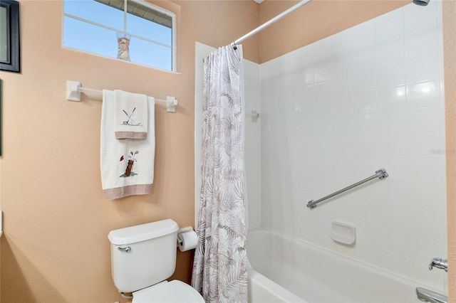 bathroom featuring shower / tub combo and toilet