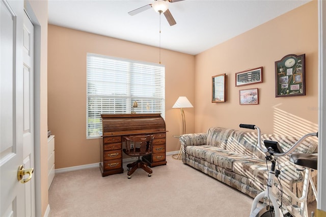 carpeted office space with ceiling fan