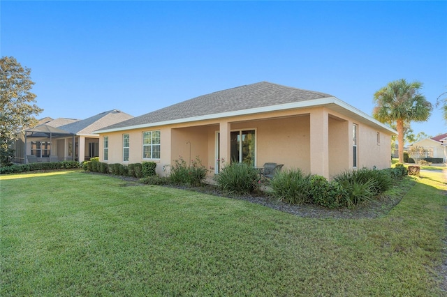 rear view of property featuring a yard