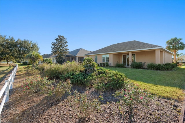 ranch-style home featuring a front yard