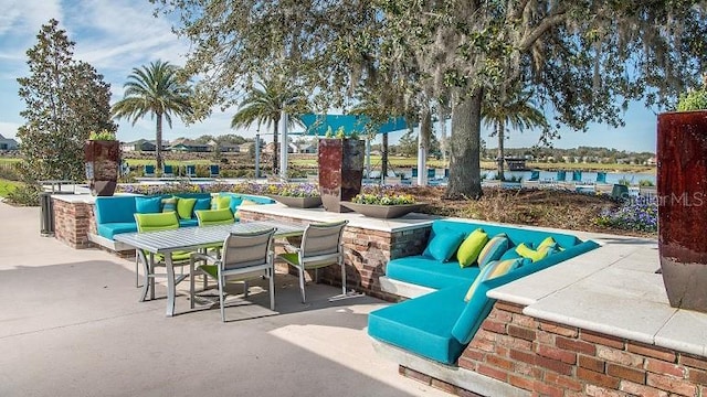 view of patio featuring outdoor lounge area and a water view