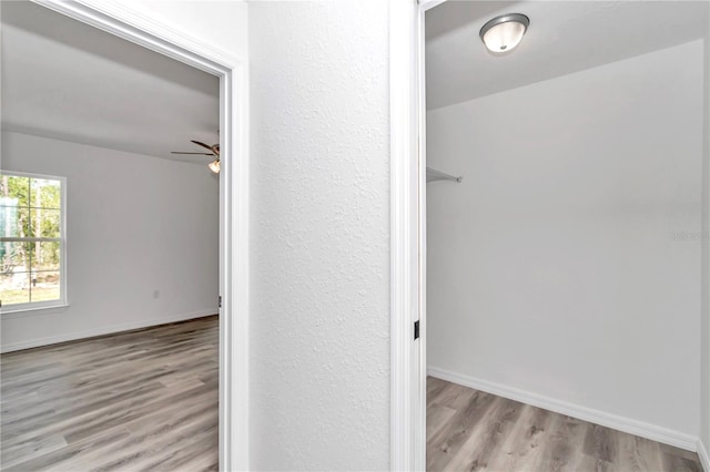 hallway with light hardwood / wood-style floors