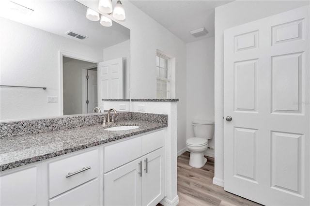 19925 SW Lark Dr, Dunnellon, FL 34431 - bathroom with vanity, wood finished floors, toilet, and baseboards