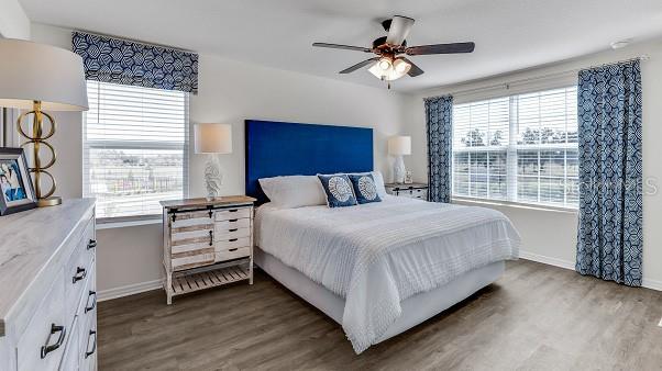 bedroom featuring ceiling fan and dark hardwood / wood-style flooring