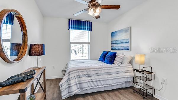 bedroom with wood-type flooring and ceiling fan