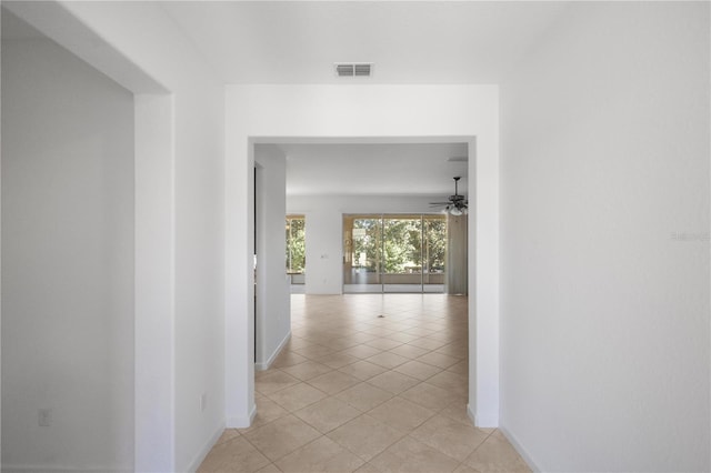 corridor featuring light tile patterned flooring