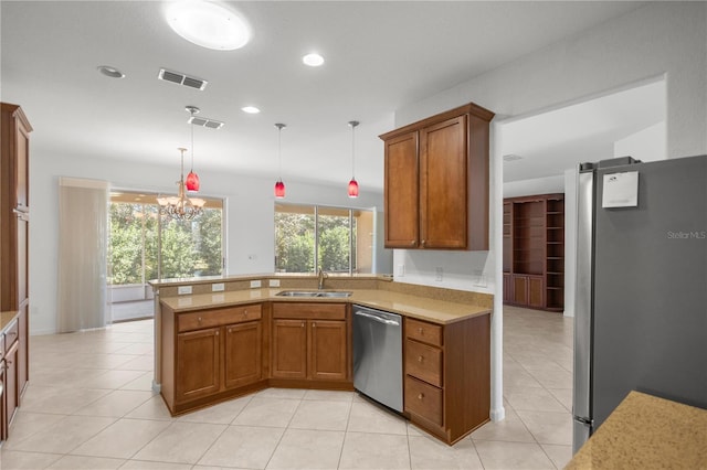 kitchen featuring pendant lighting, sink, a notable chandelier, kitchen peninsula, and stainless steel appliances