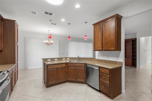 kitchen featuring kitchen peninsula, stainless steel appliances, hanging light fixtures, and sink