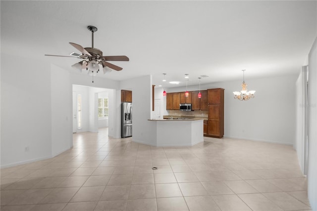 unfurnished living room with ceiling fan with notable chandelier and light tile patterned flooring