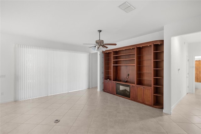 unfurnished living room featuring ceiling fan and light tile patterned floors