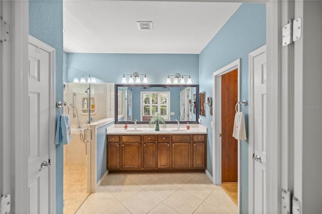 bathroom with vanity, tile patterned floors, and a shower with shower door