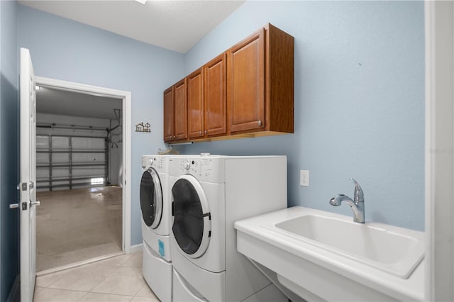 laundry room with cabinets, independent washer and dryer, light tile patterned floors, and sink