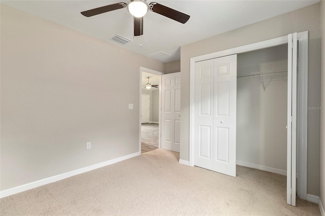 unfurnished bedroom featuring a closet, light colored carpet, and ceiling fan